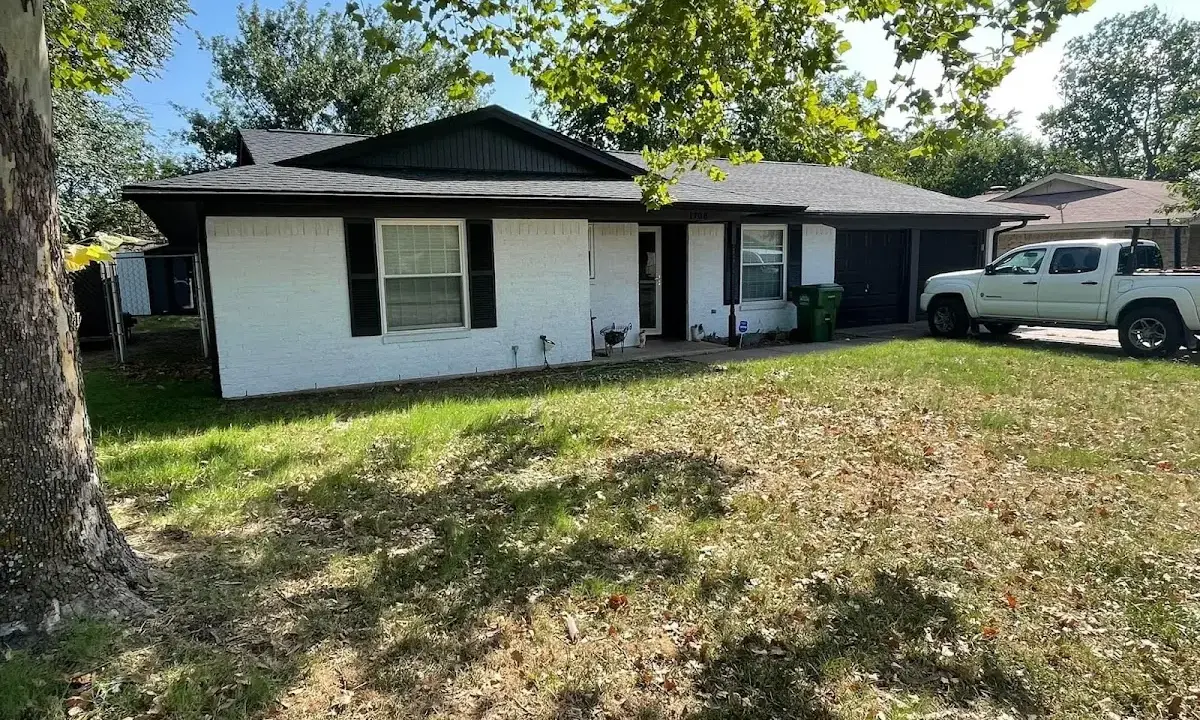 Professional roofing crew working on a residential roof in Gladstone